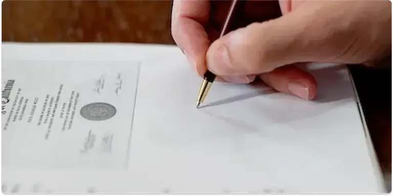 Picture of a person signing a document