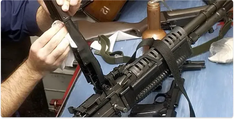 Picture of a Man cleaning a rifle