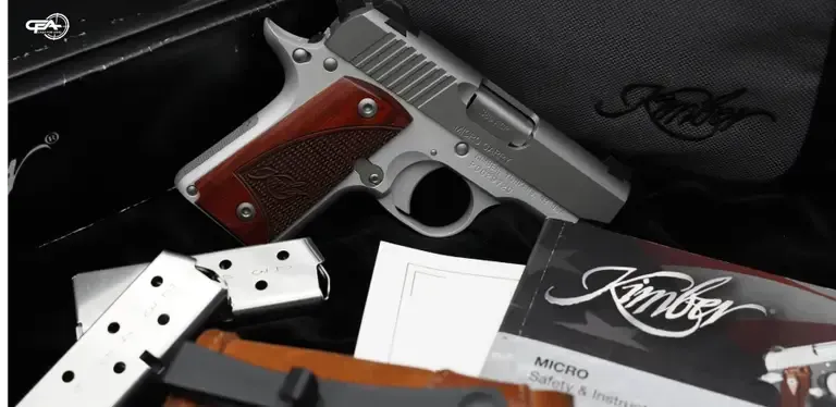 Picture of a Kimber Micro Carry 380 with two magazines and a Kimber bag