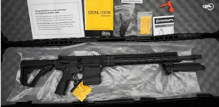 Picture of a Daniel Defense DD5 in a case with some documentation