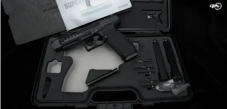 Picture of a Canik SFx in a case with two magazines and some documentation
