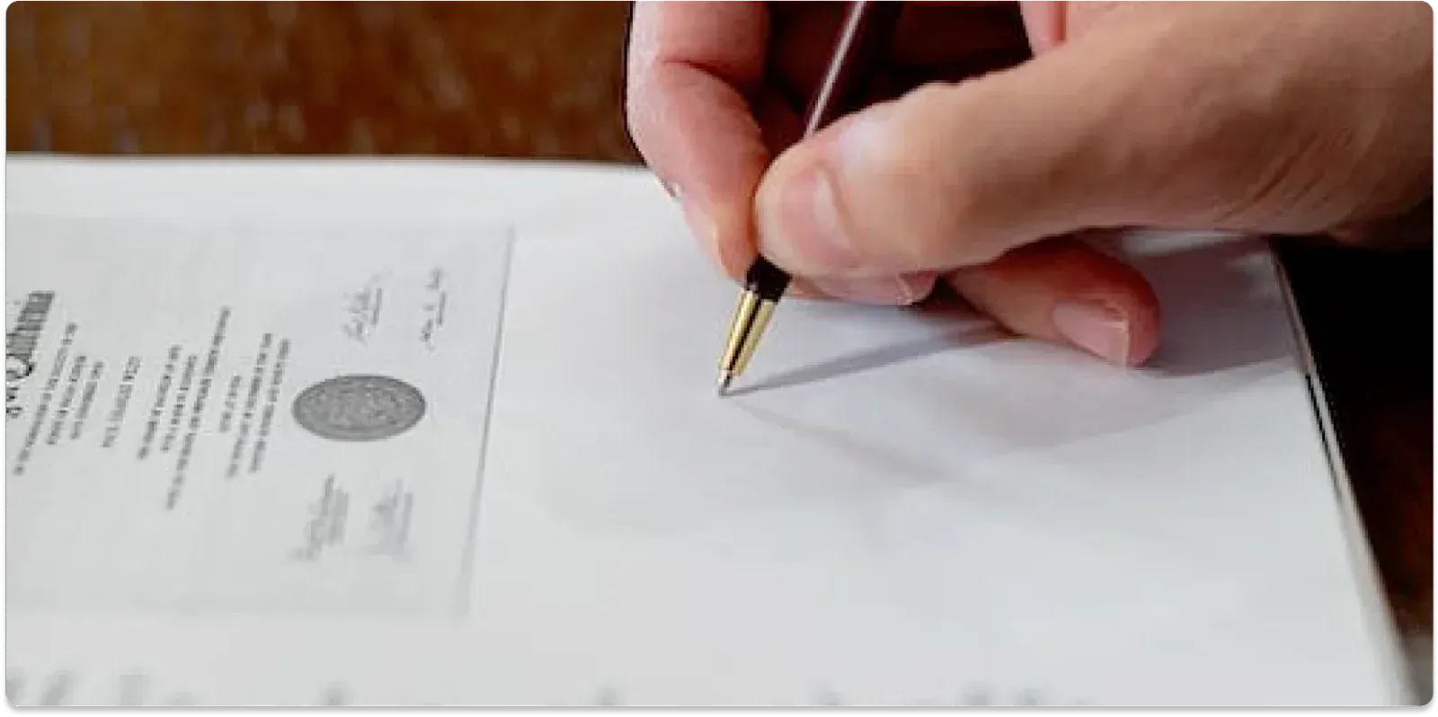 Picture of a person signing a document