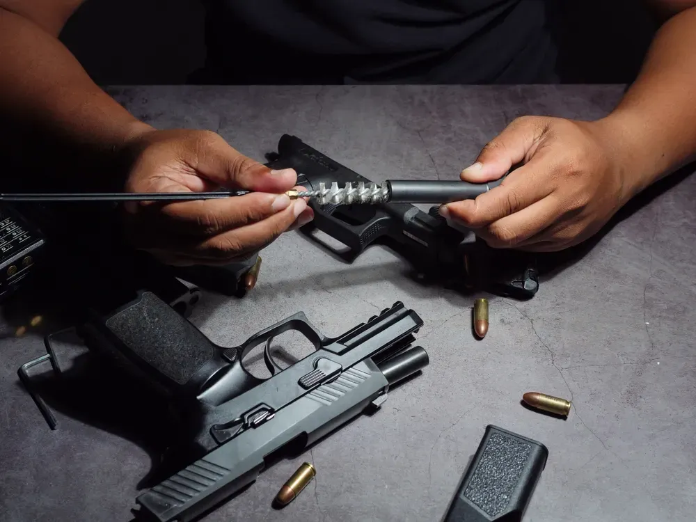 Person cleaning a handgun
