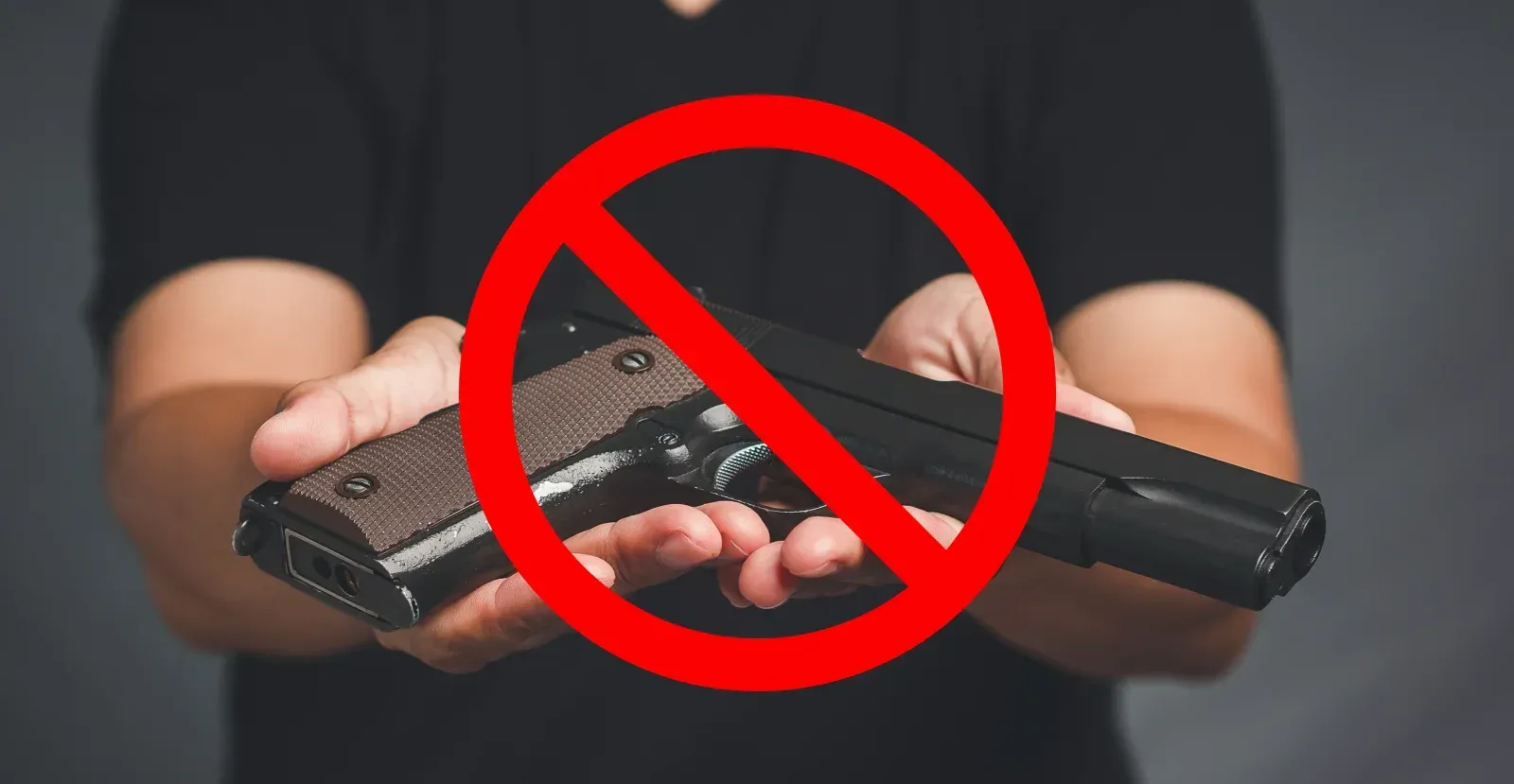 Person holding out gun with a red slash on it
