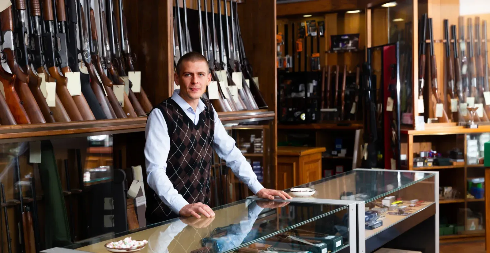 Person standing behind the counter in a gun store