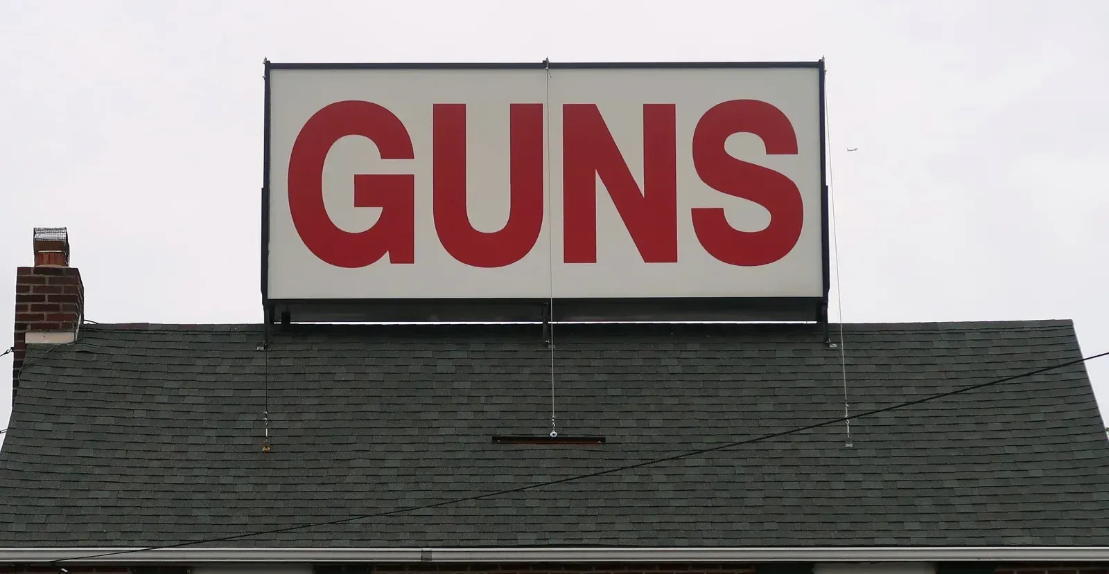 Gun sign on top of building