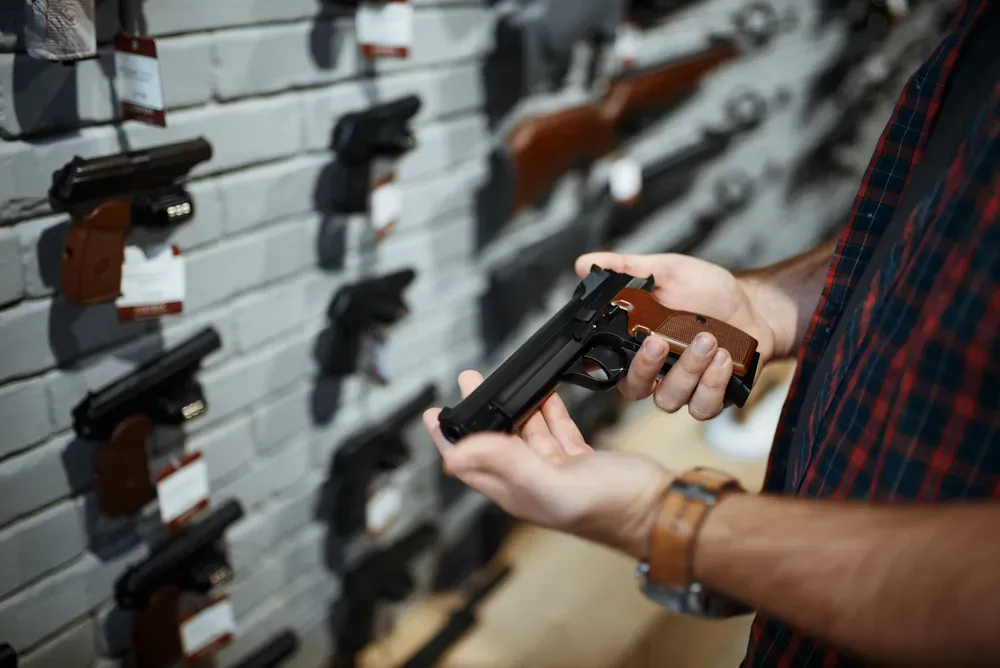 Person holding a handgun inside a gun store
