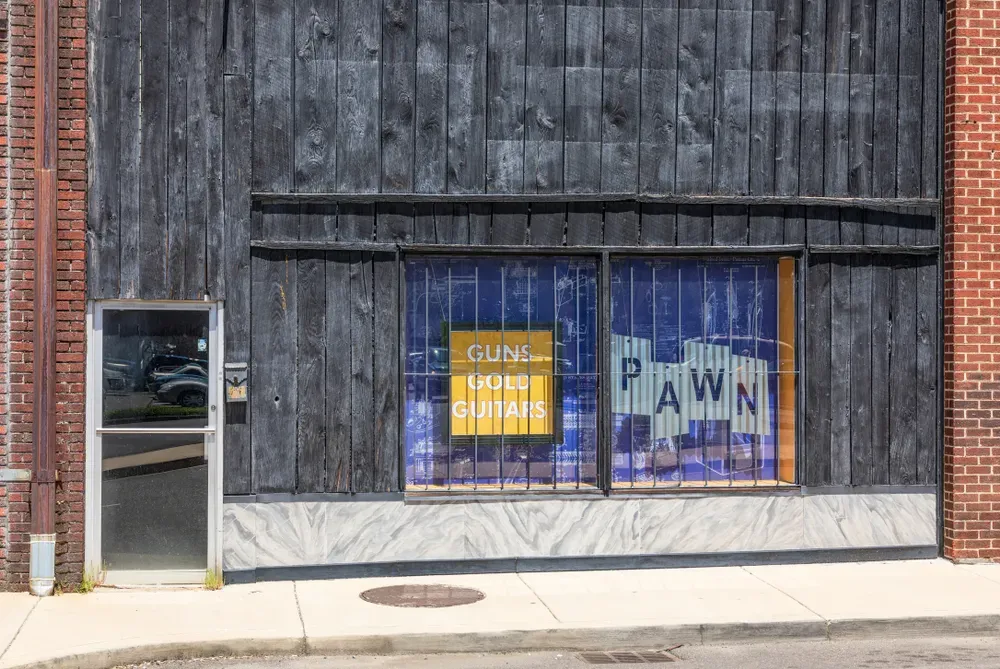 Outside of a pawn shop that sells guns, gold and guitars
