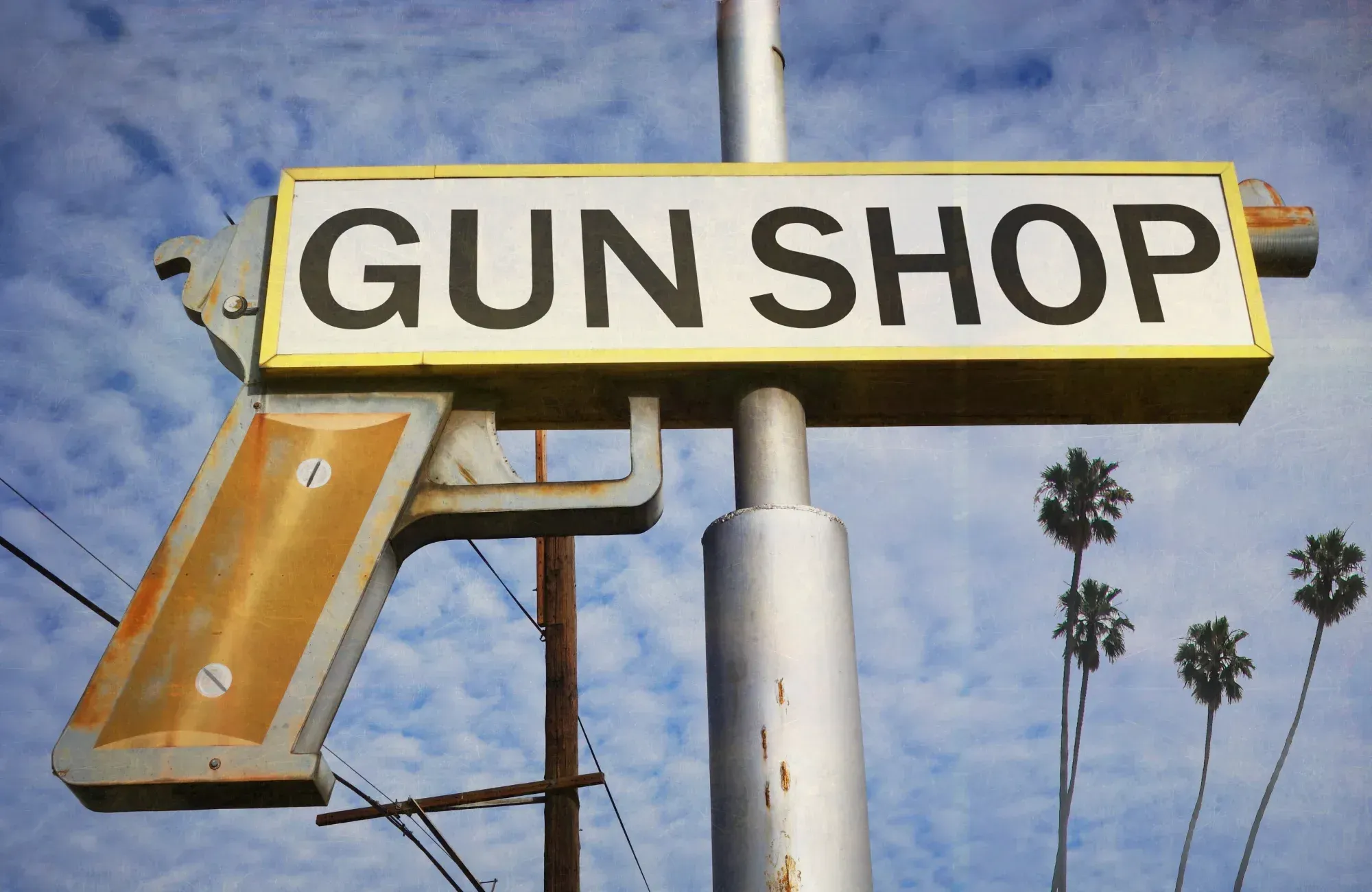 Gun shop sign on a pole