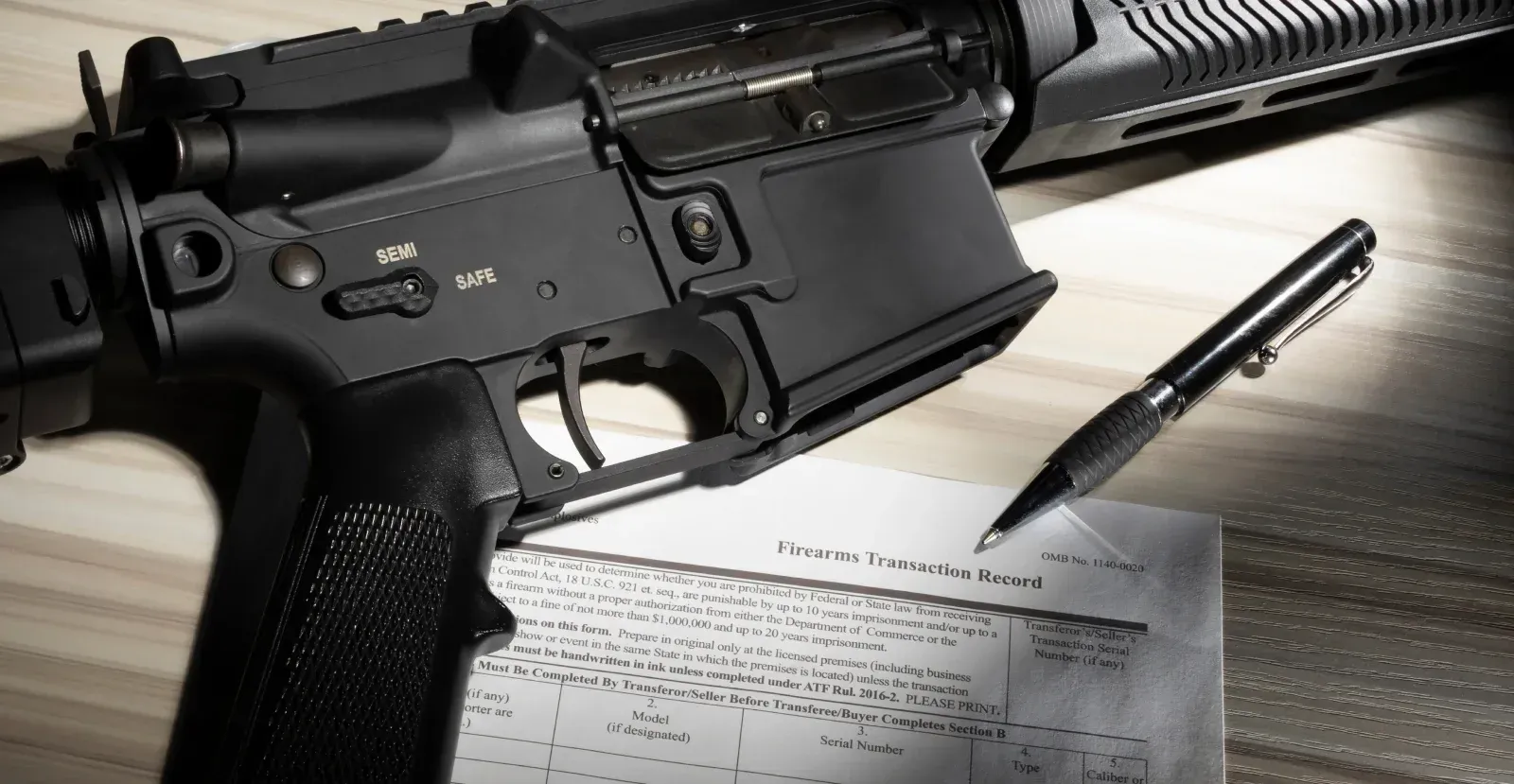 Semi-auto rifle laying on a Firearms Transaction Record form