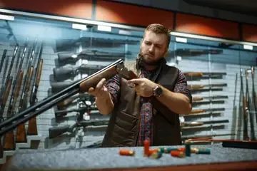 Man examining a shotgun