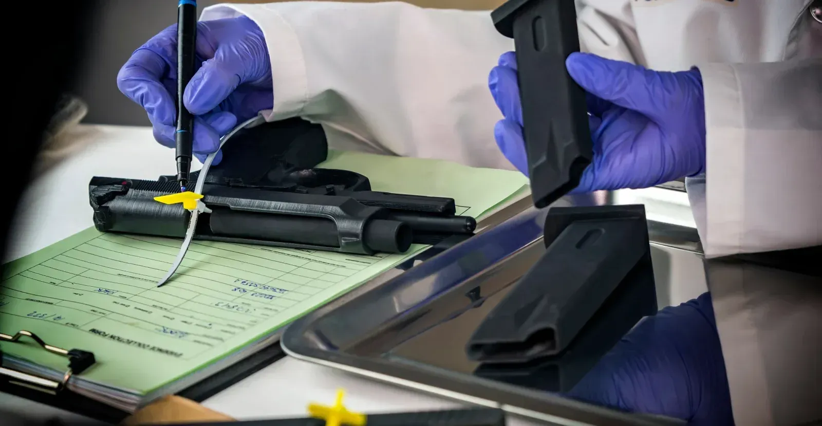 Handgun being logged with a form