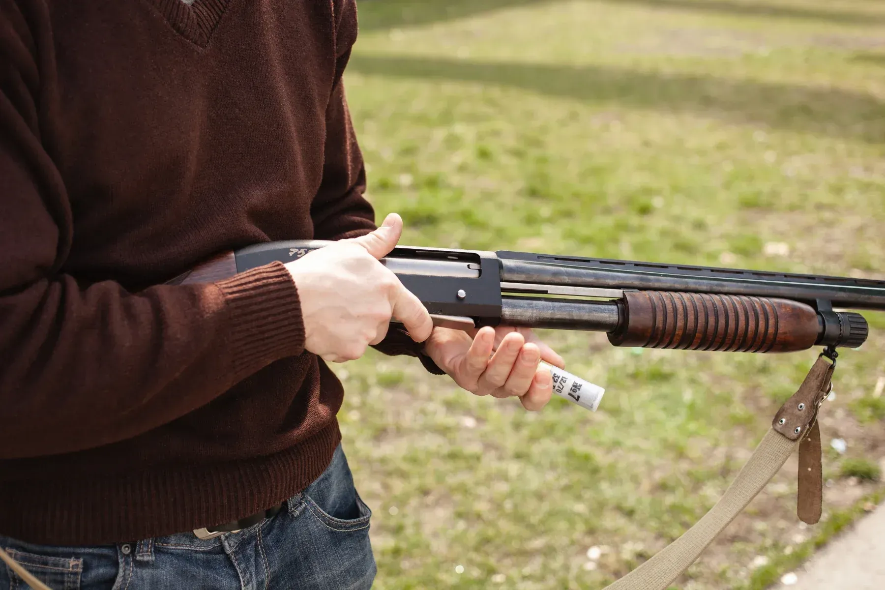 Picture of a person holding a Remington 870