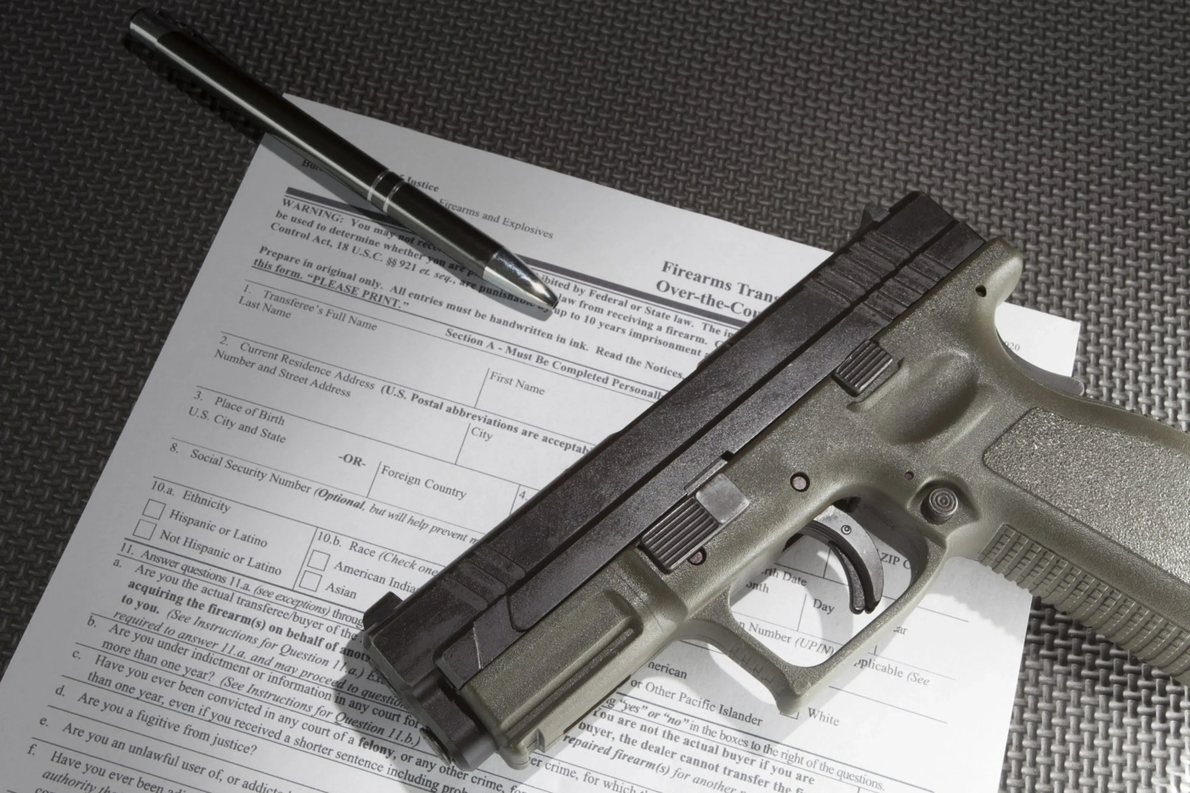 A pistol, a pen, and a transaction record
