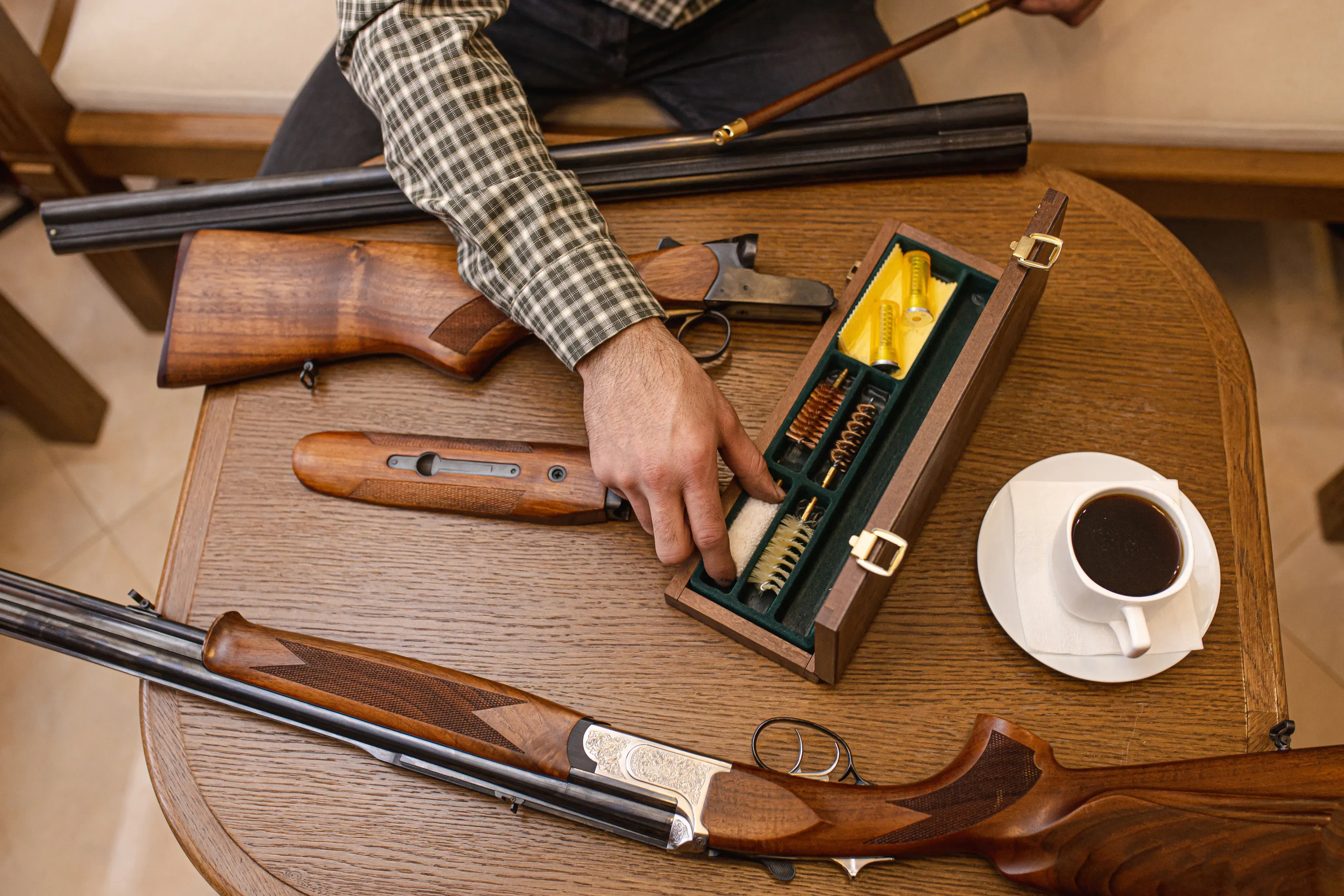 A man cleaning his gun collection