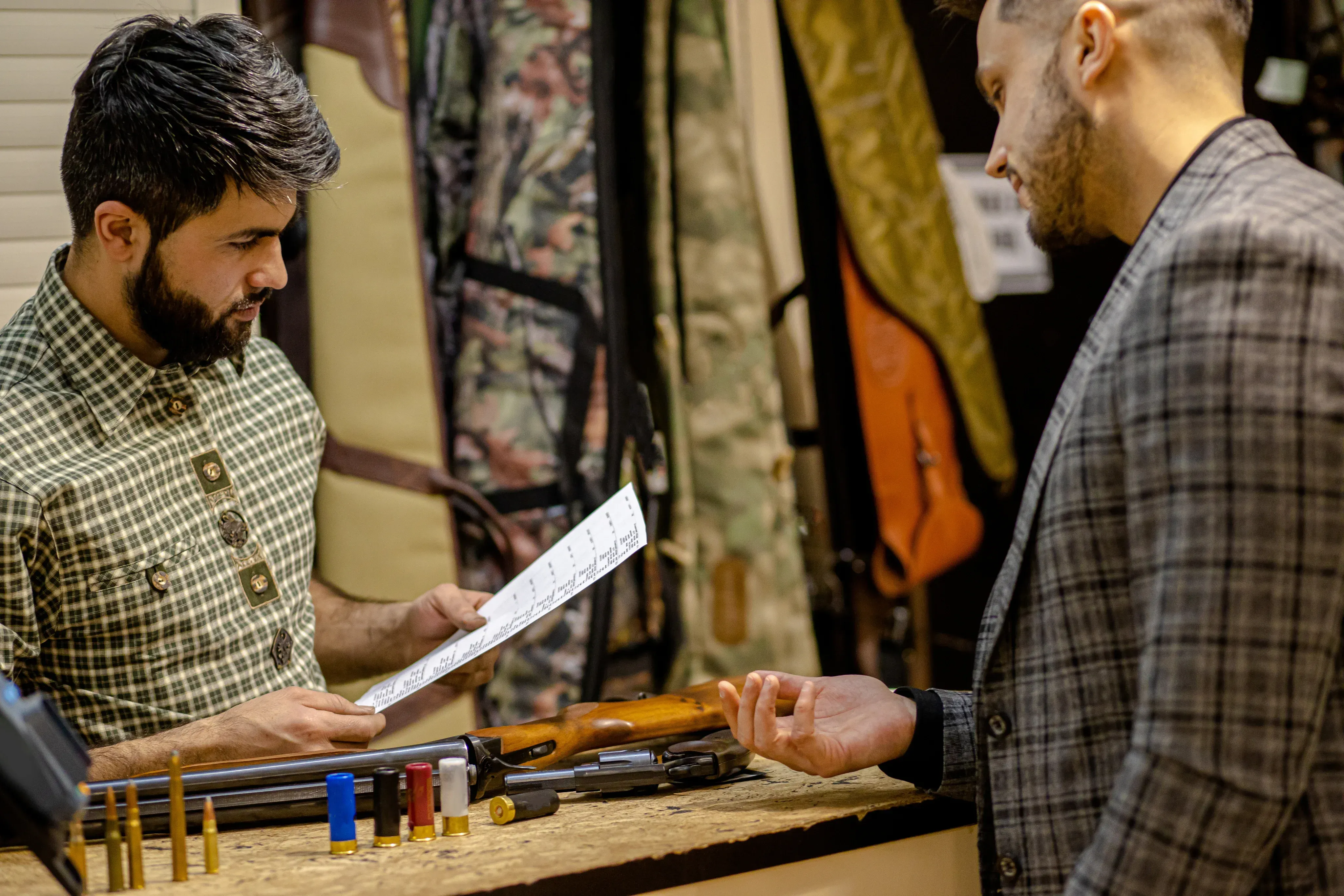 A man examining a document given by another man