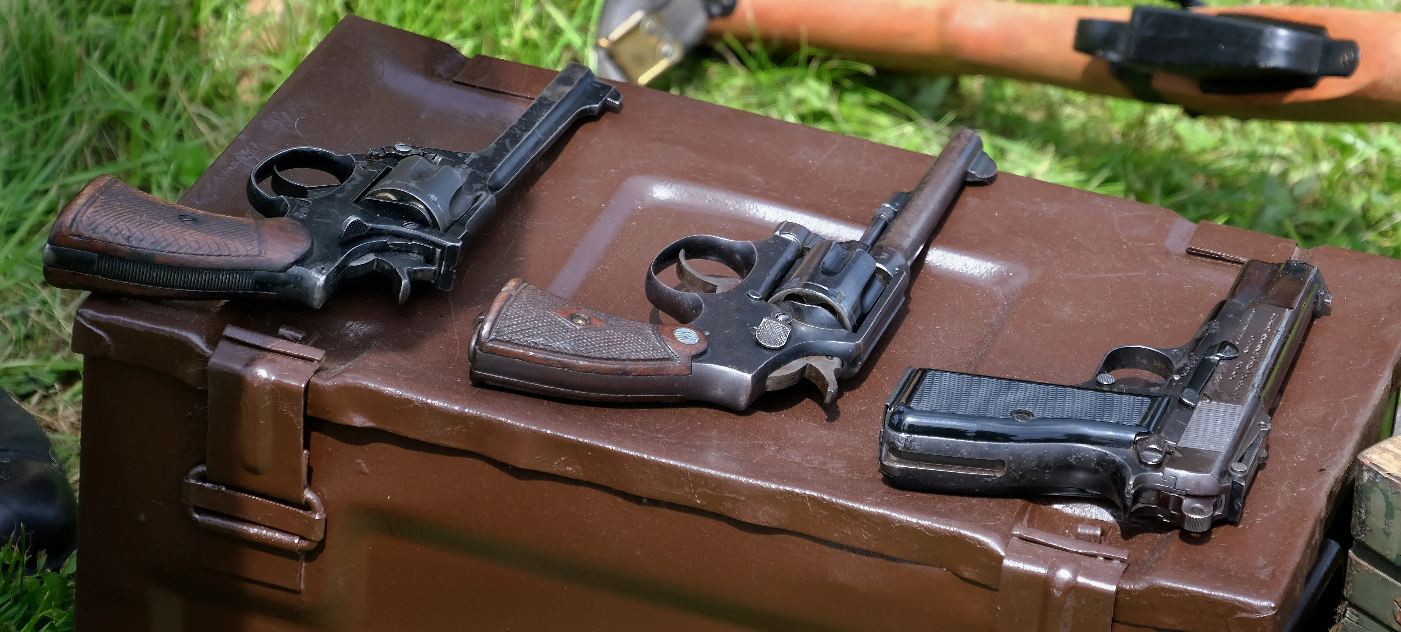Two revolvers and a handgun on a case