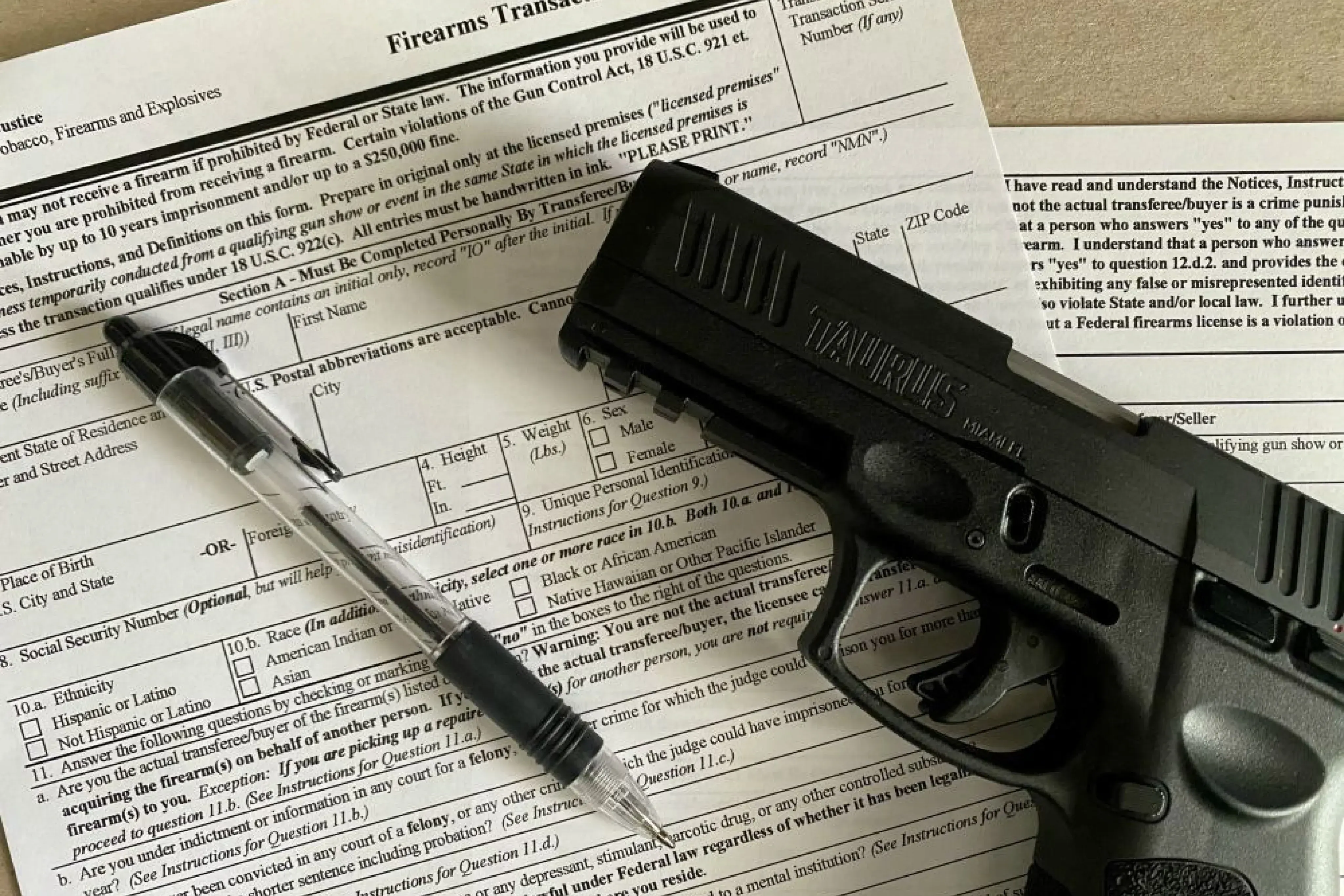 A pistol, pen, and transaction record
