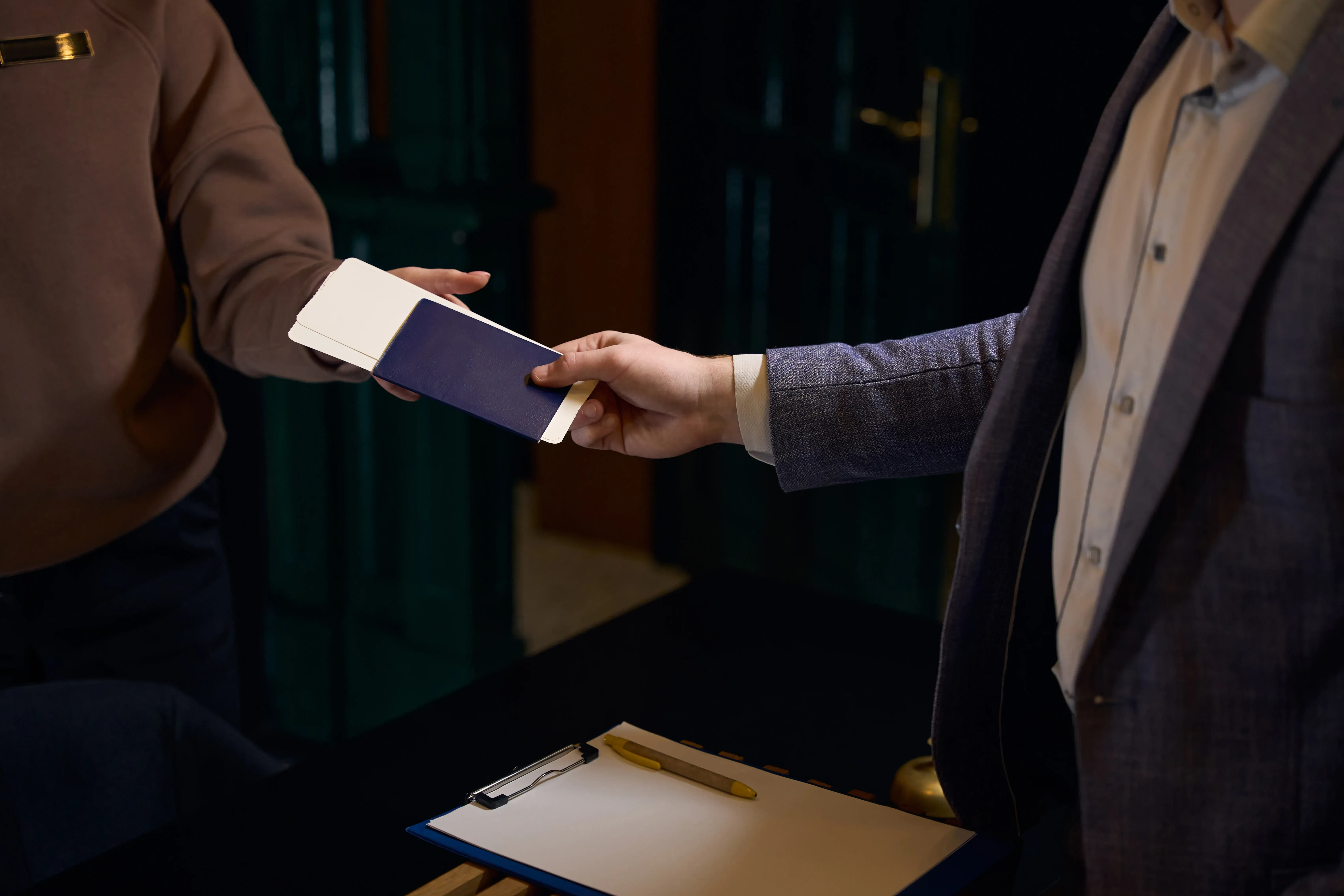 A person handing a document to another person