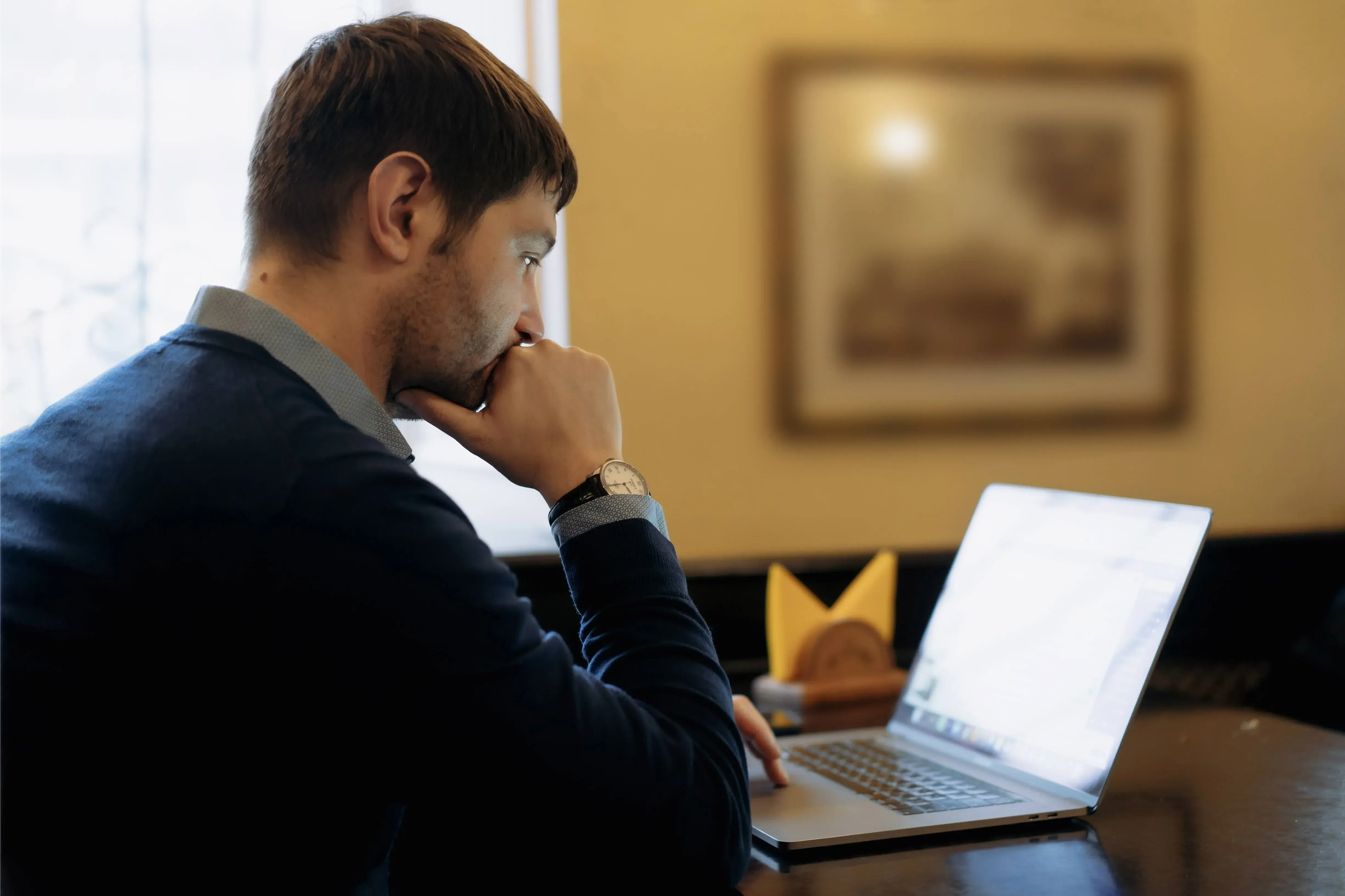 A man looking at his laptop