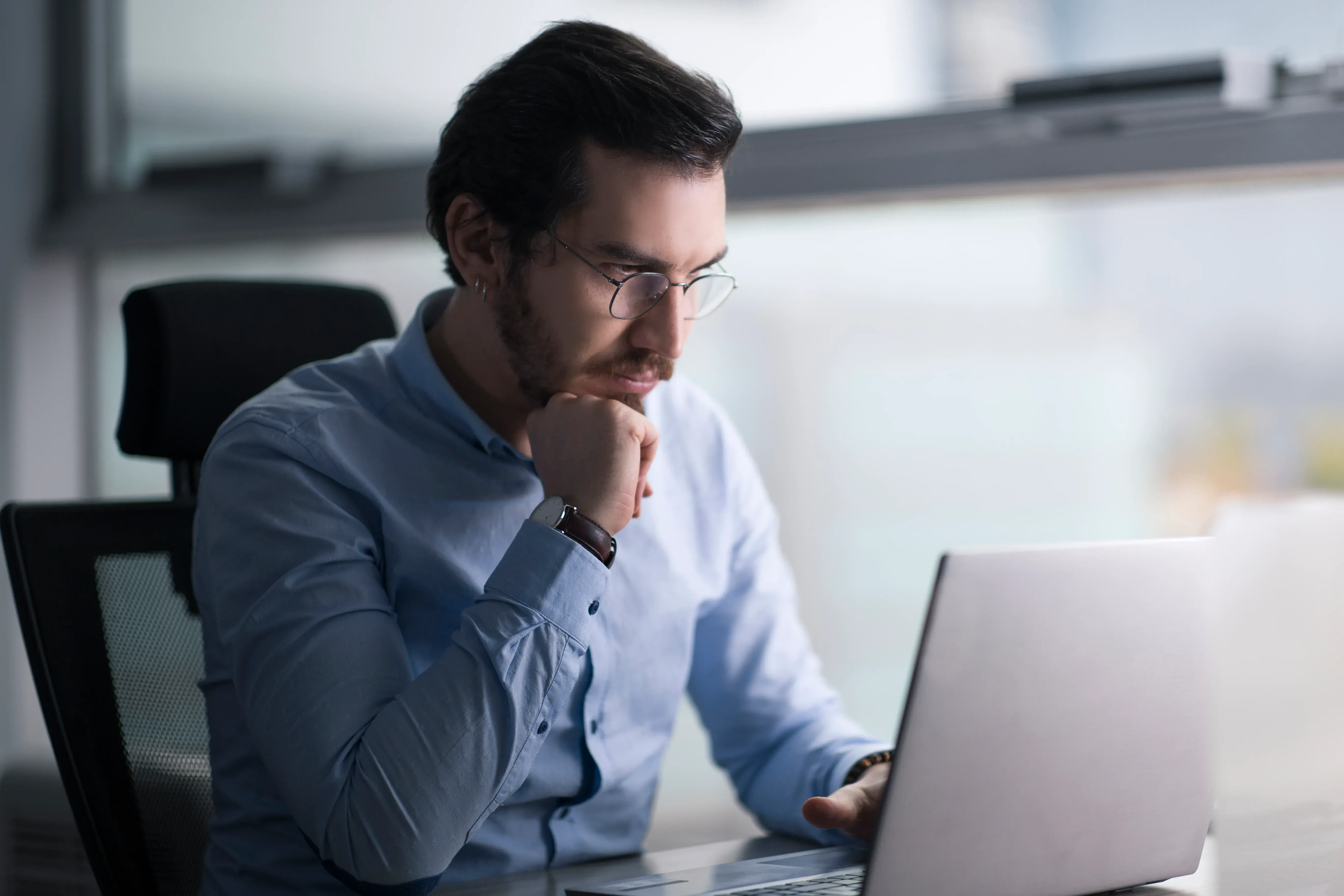 A man examining something on his laptop
