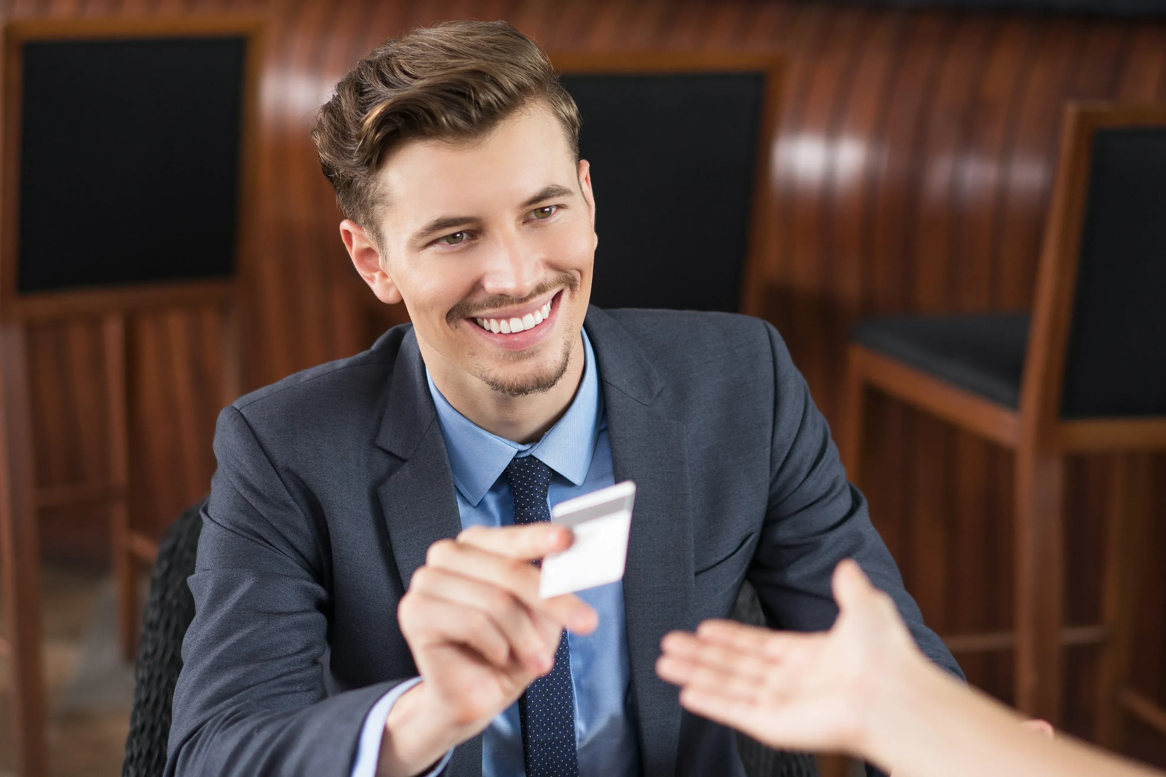 A man handing an identification card