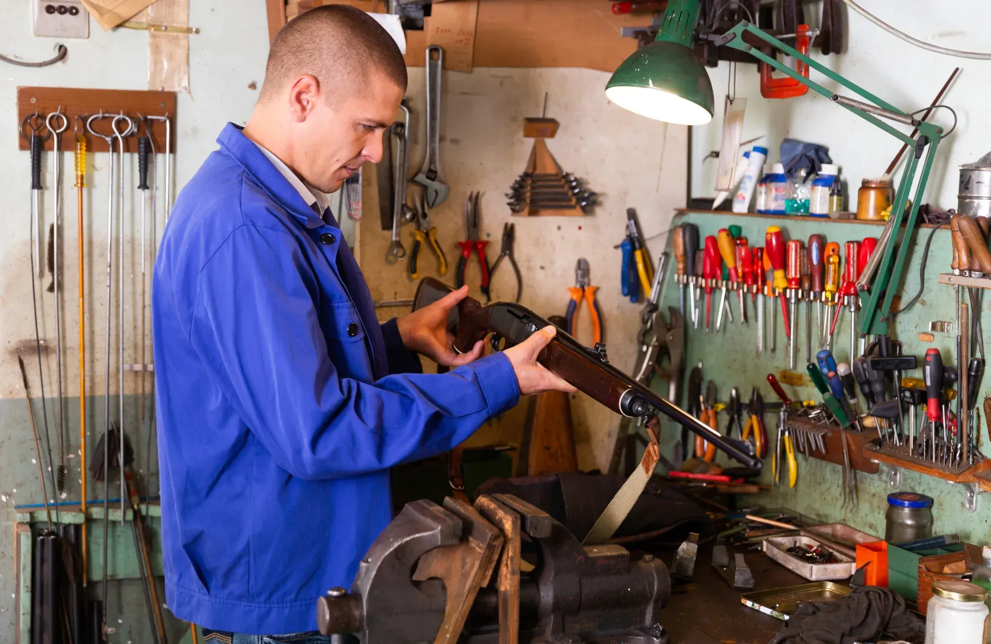 Man holding a shotgun in the garage