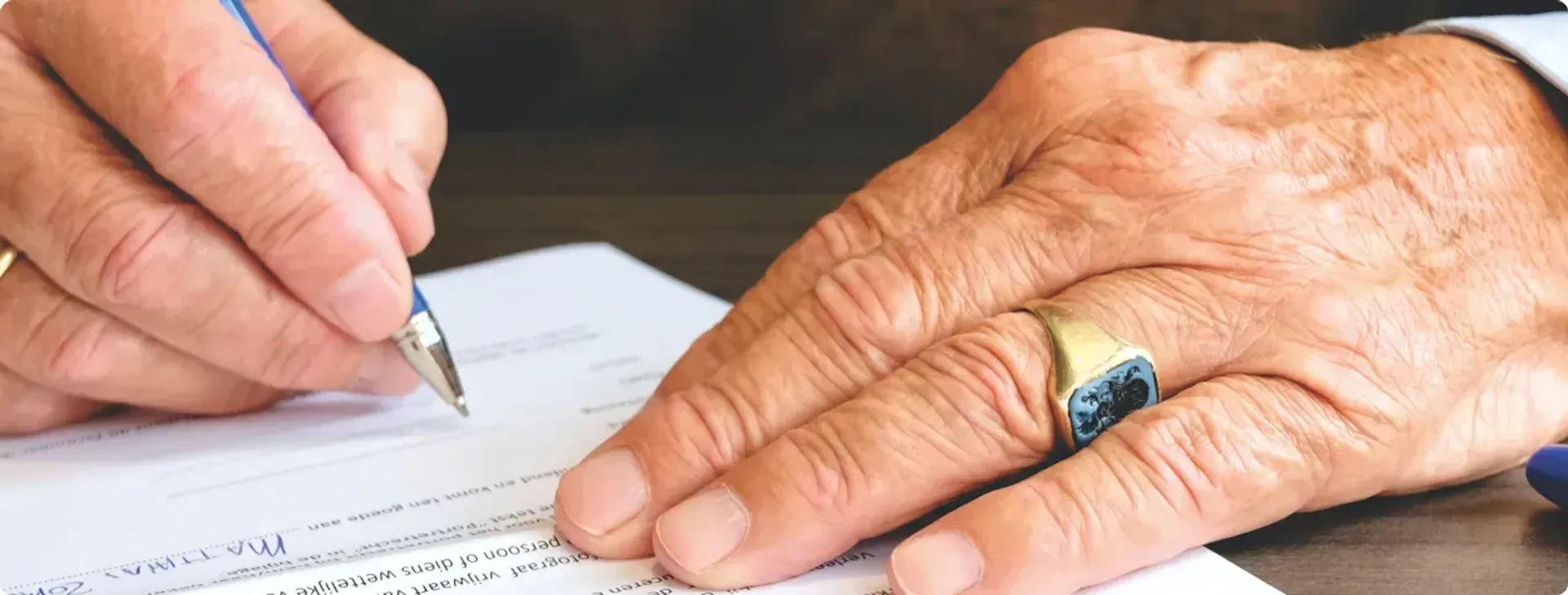 Person writing records with pen on paper