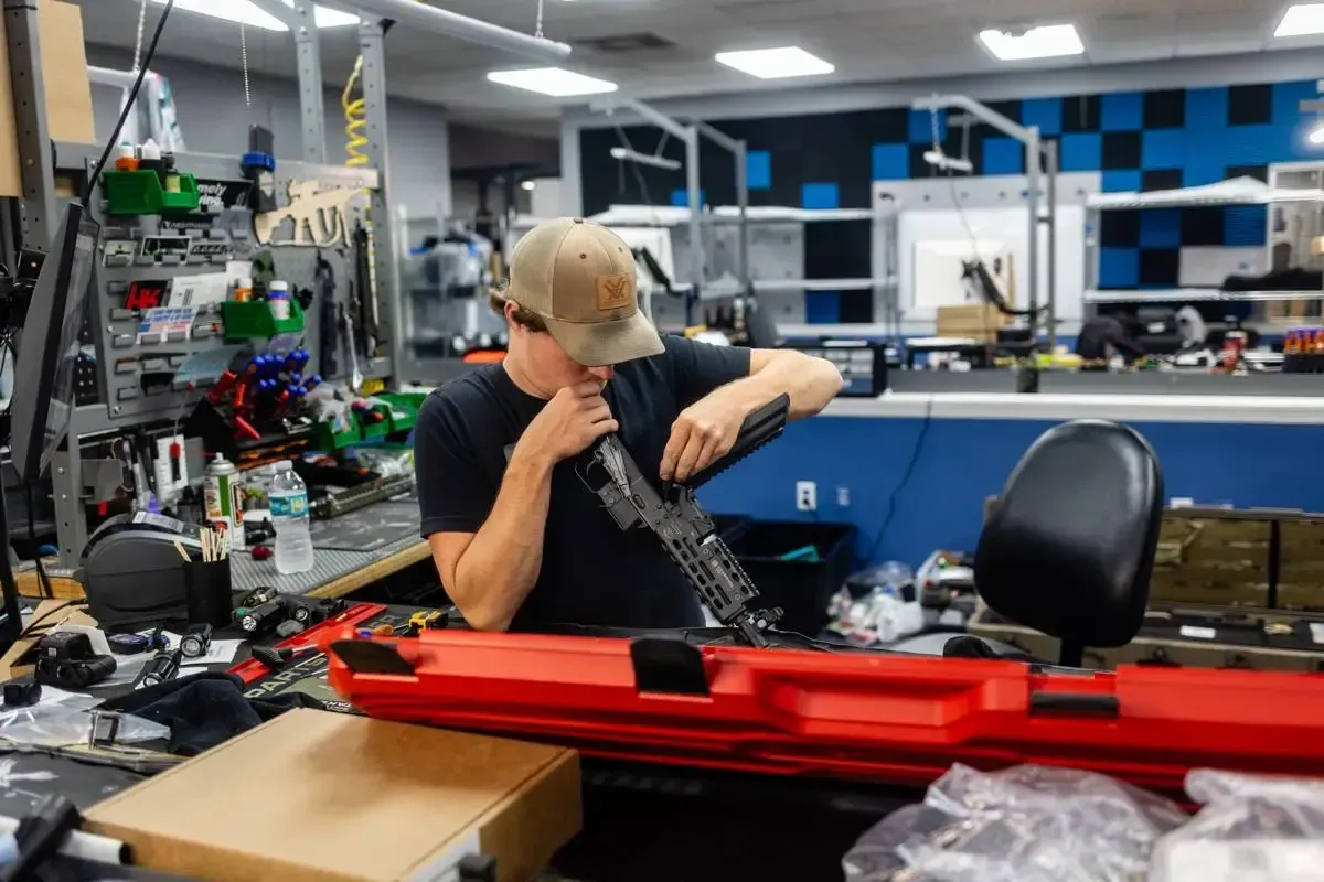 Licensed appraiser inspecting a rifle at Cash for Arms in Jacksonville, Florida